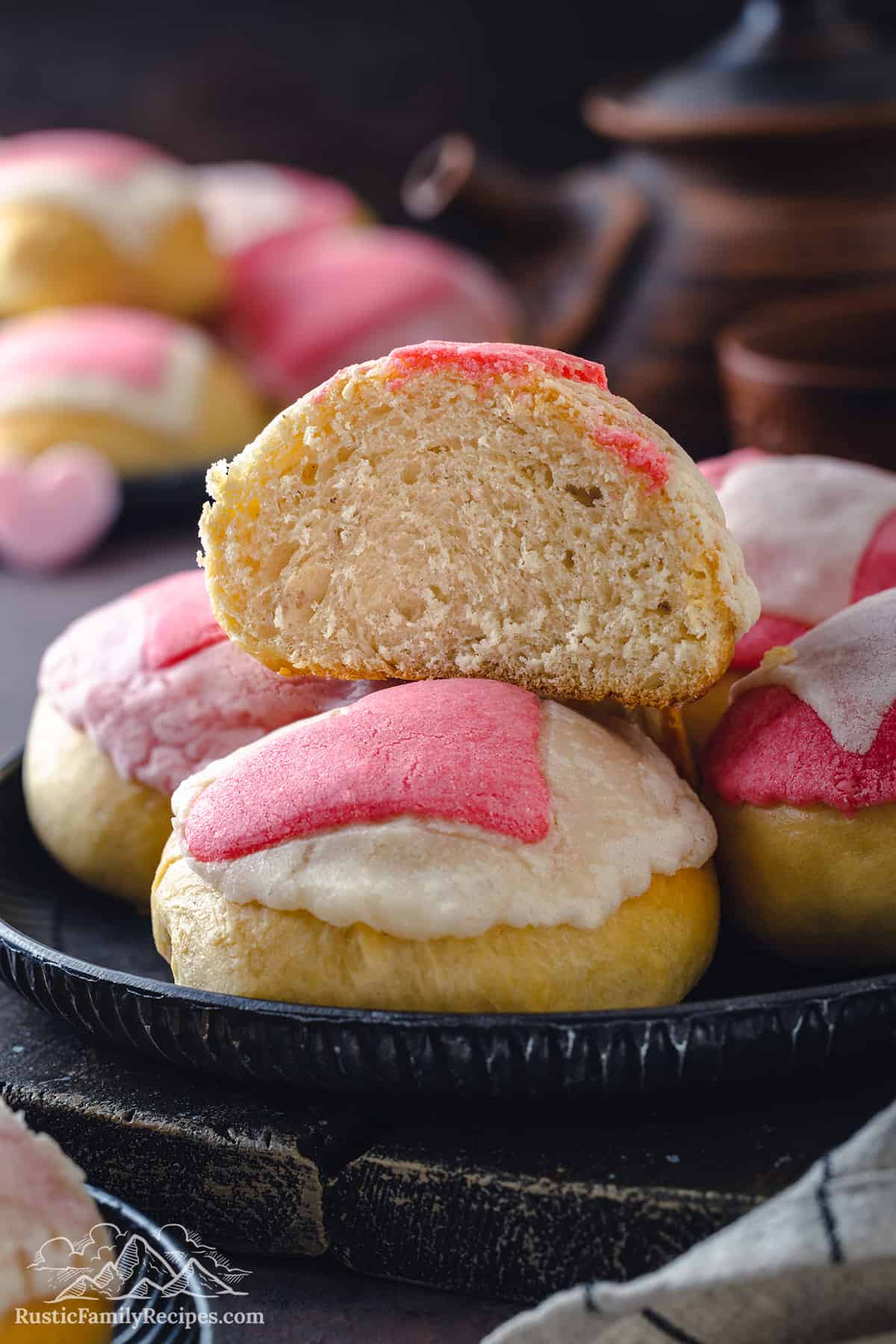 Pile of Valentines Conchas, one cut in half to see the fluffy interior