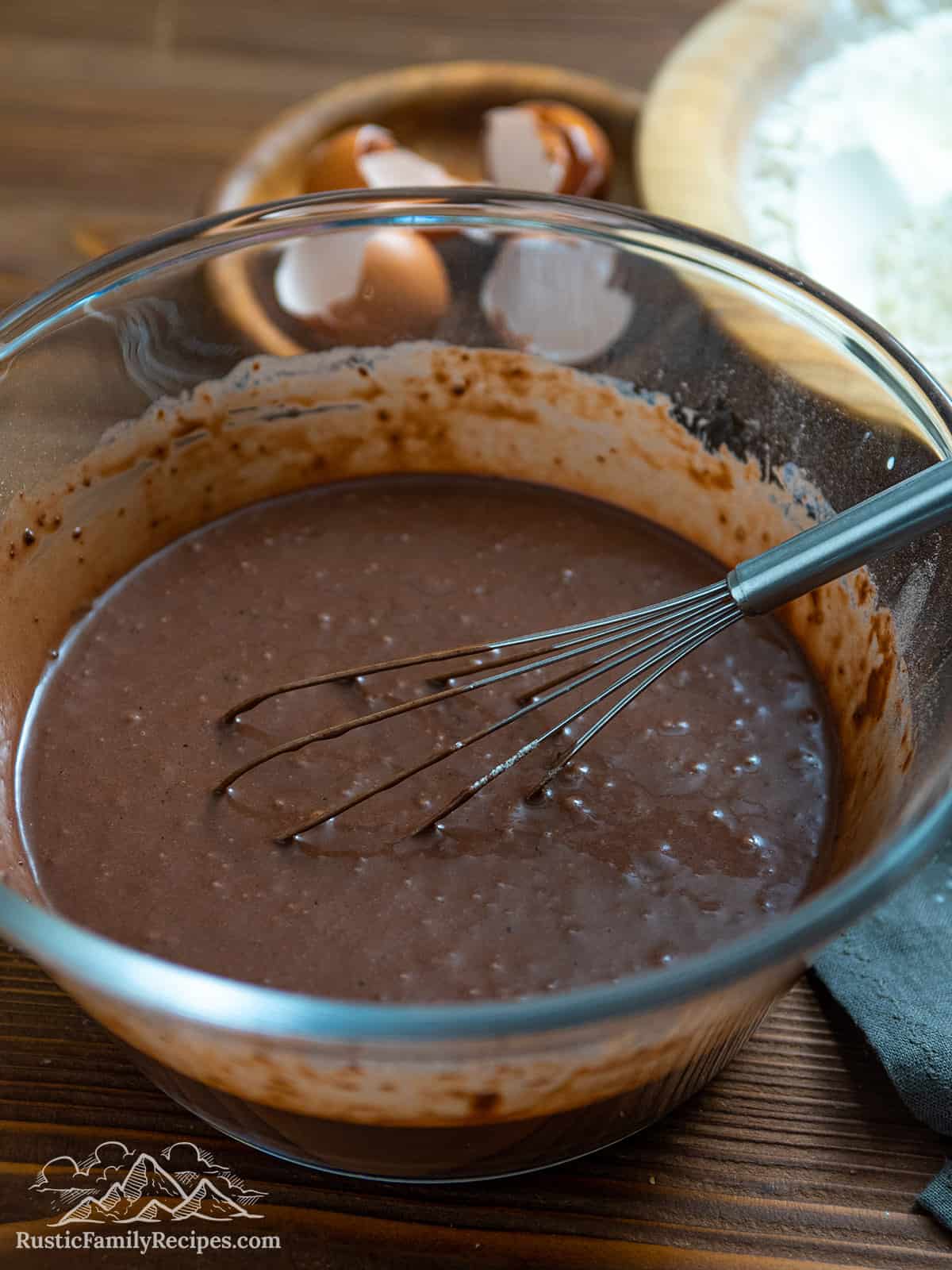 Mixing chocolate pancake batter in a glass bowl
