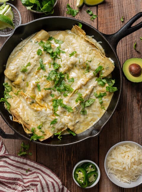 Skillet filled with enchiladas suizas.