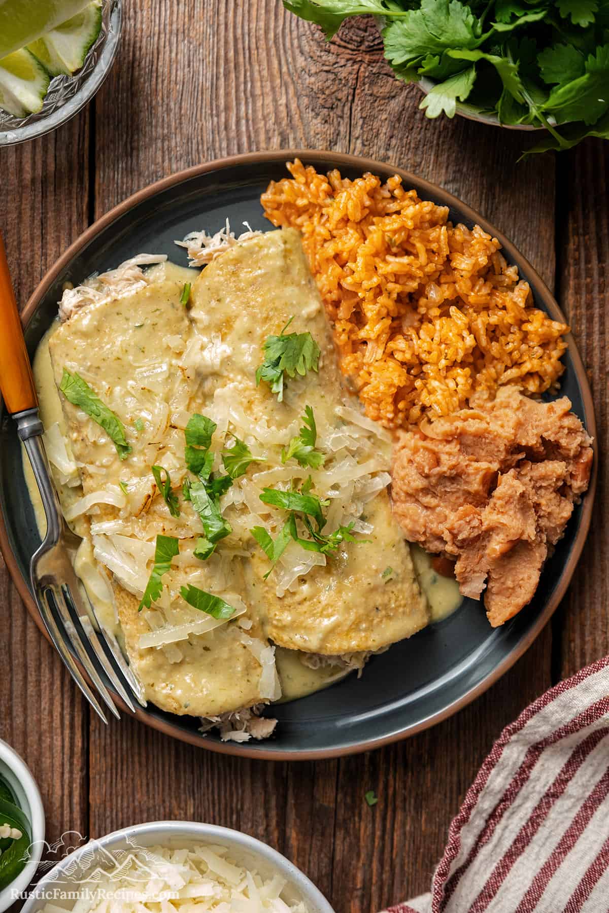 Enchiladas suizas with a side of refried beans and red rice. 