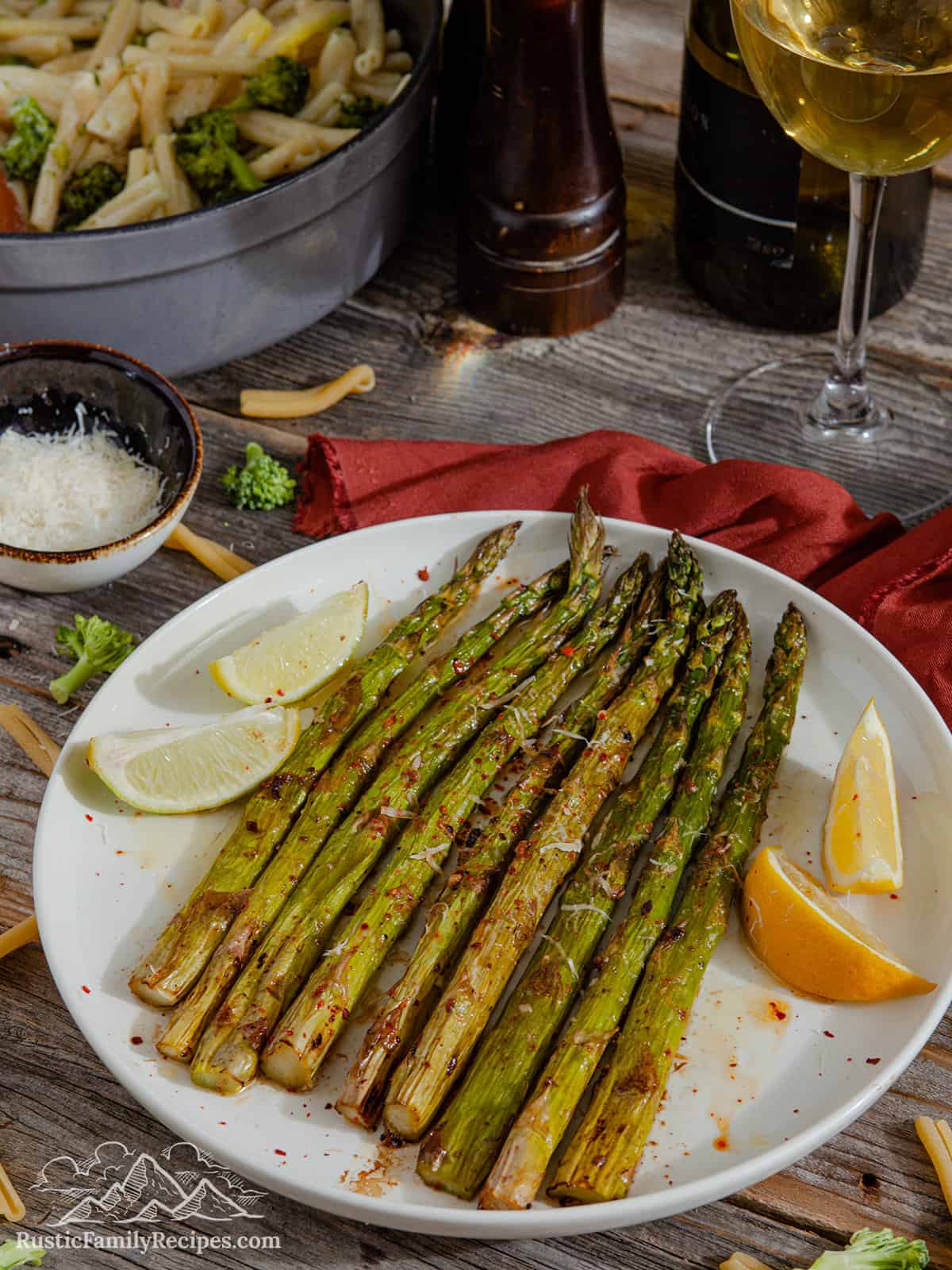 Roasted asparagus on a white plate with lemon