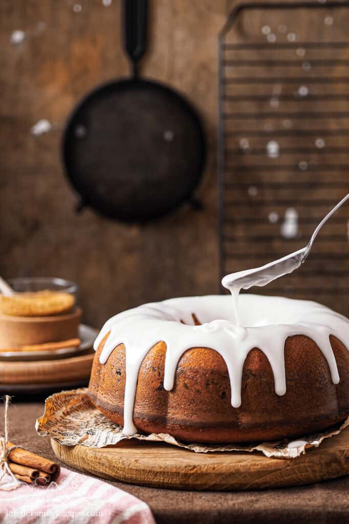 Adding icing to a Sock it to Me Cake