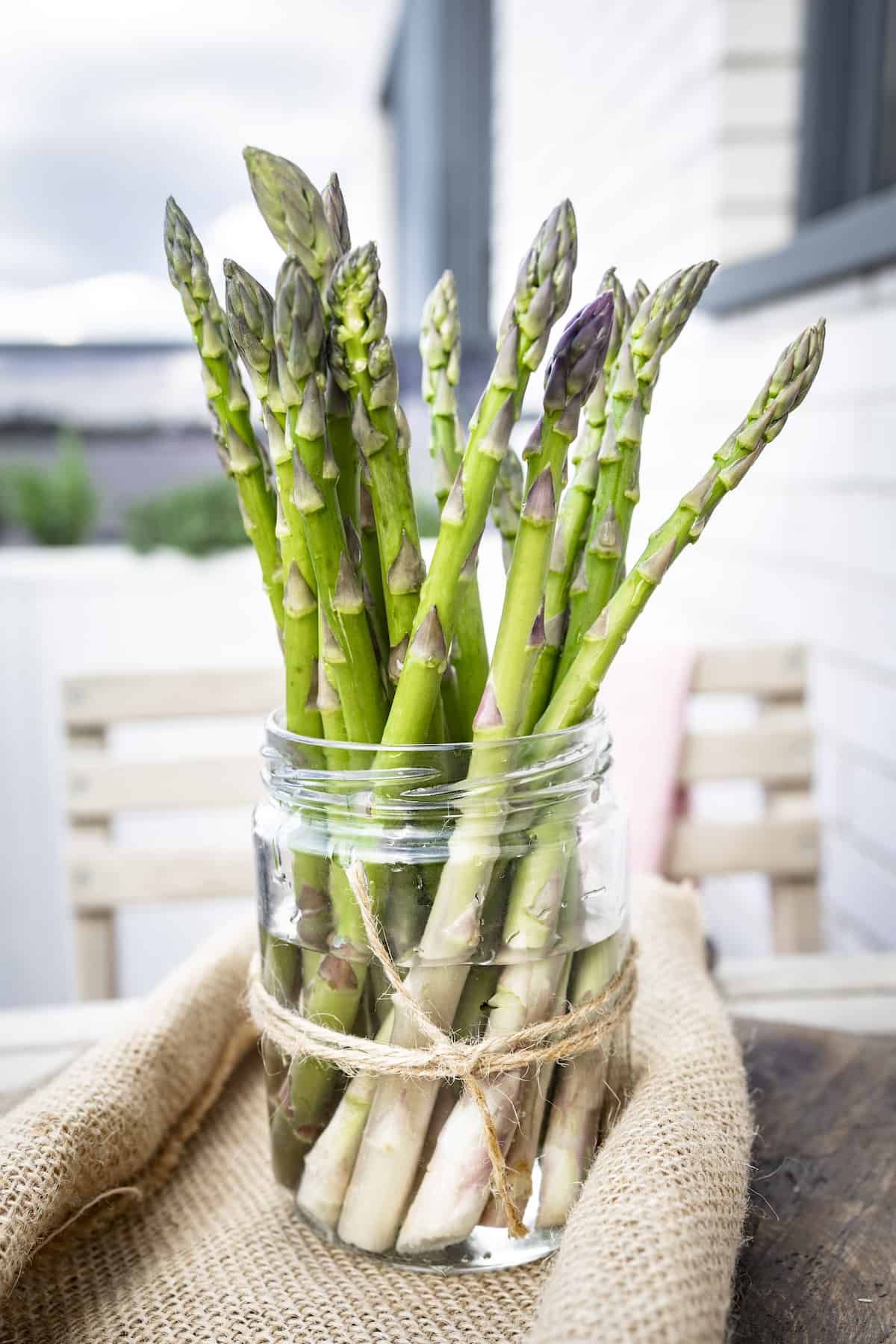 Fresh asparagus in a mason jar with water.