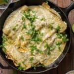 Skillet filled with enchiladas suizas.