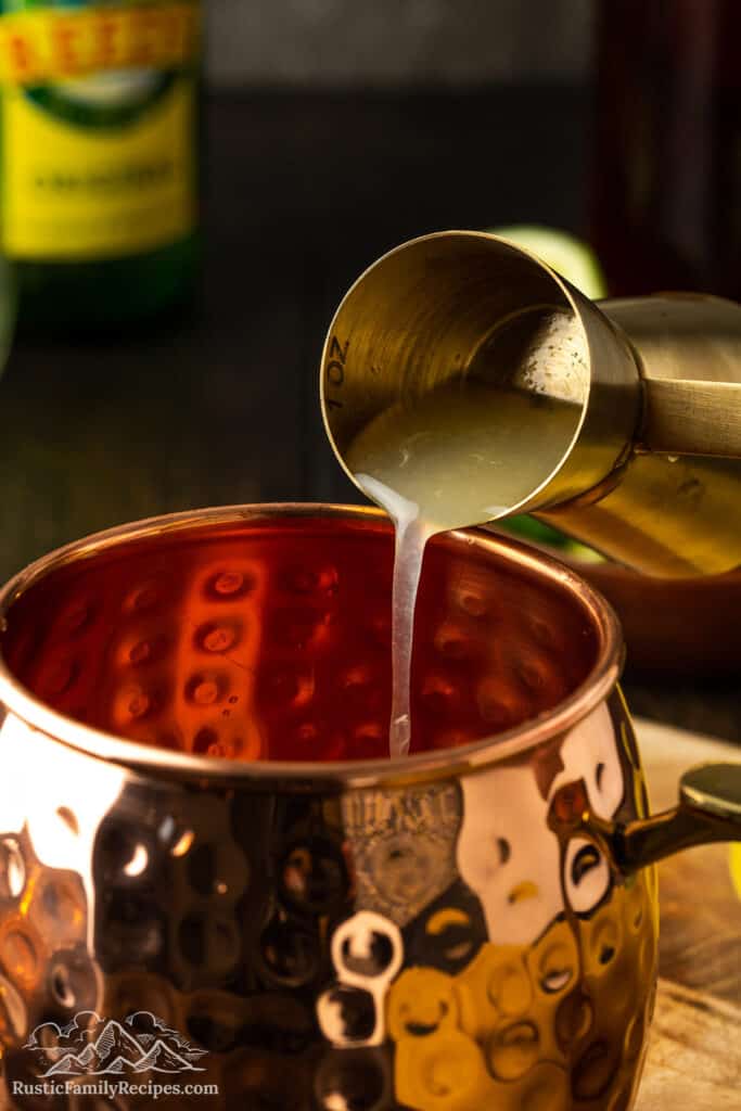 Add lime juice liquid to a copper mug