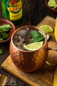 Kentucky Mule drink in a copper mug with lime wedges