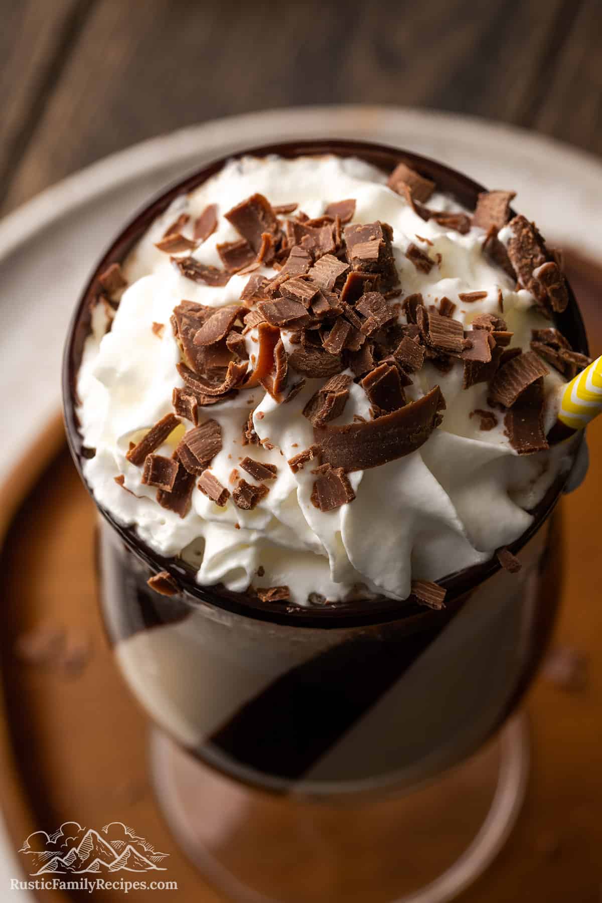 Top view of a mudslide drink in a hurricane glass topped with whipped cream and chocolate