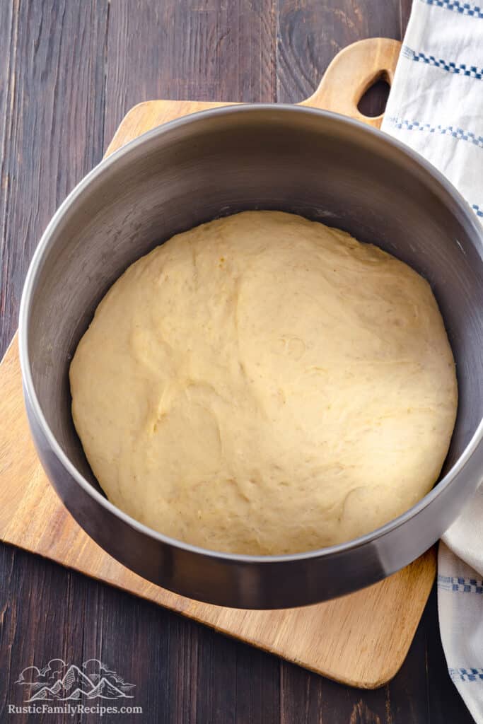 Risen dough ready to be made into donuts in a large bowl