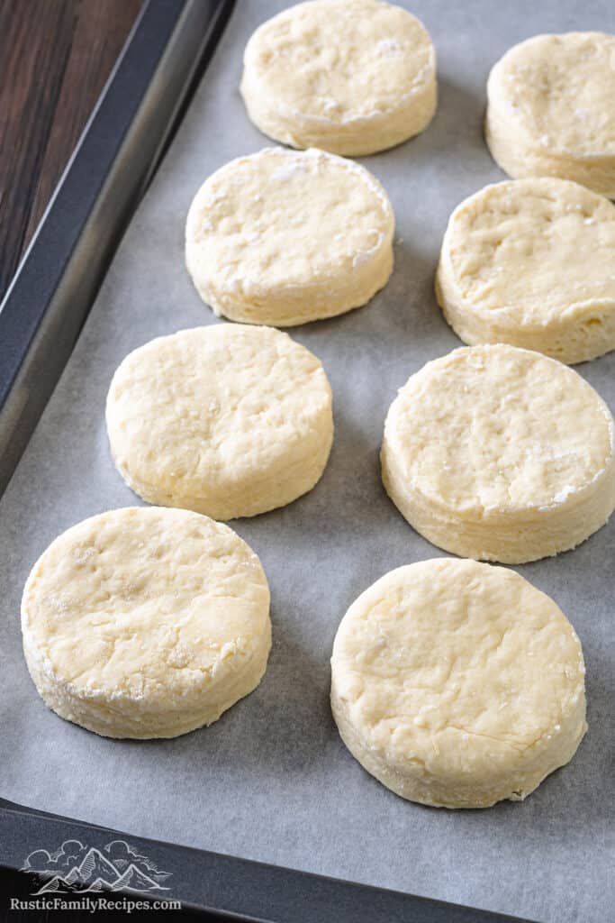 Biscuits arranged on a baking sheet ready to be baked.