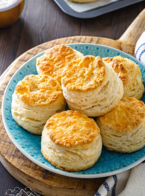 Cathead biscuits stacked on a plate.