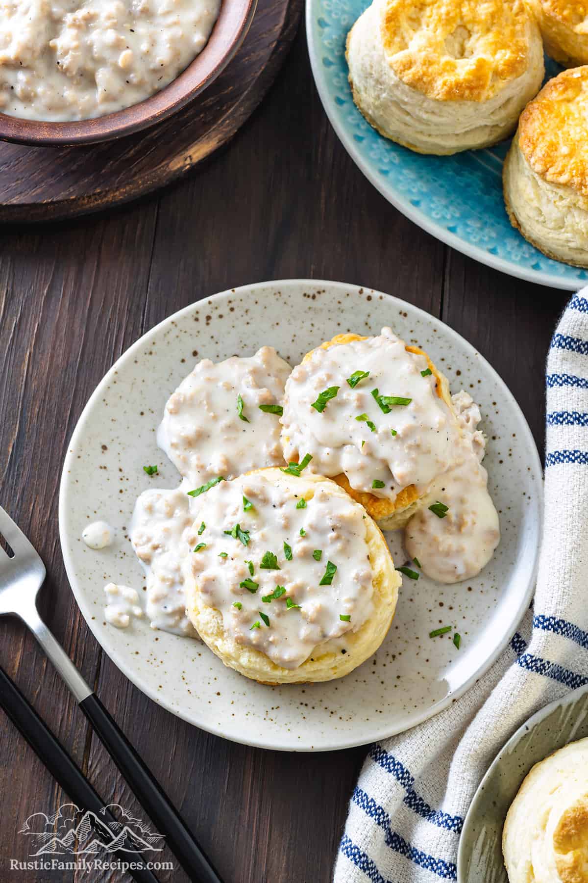 Overhead of cathead biscuits and gravy on a plate.
