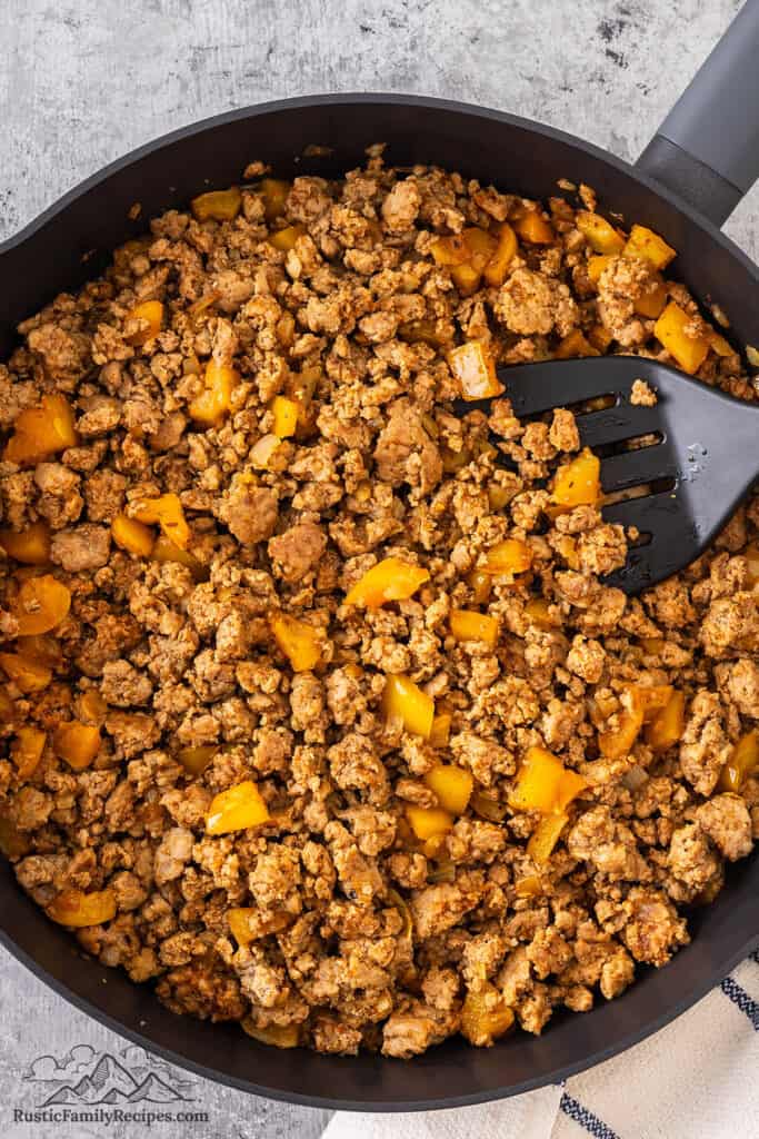 Mixing beef taco meat in a skillet