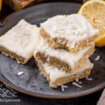 Lemon slice bars stacked on a plate.