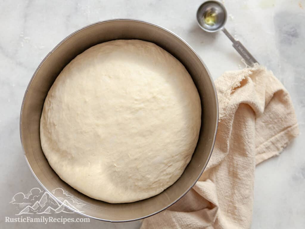 Pretzel dough in a metal bowl ready to shape
