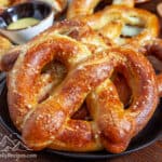 A baking sheet with a pile of jumbo pretzels