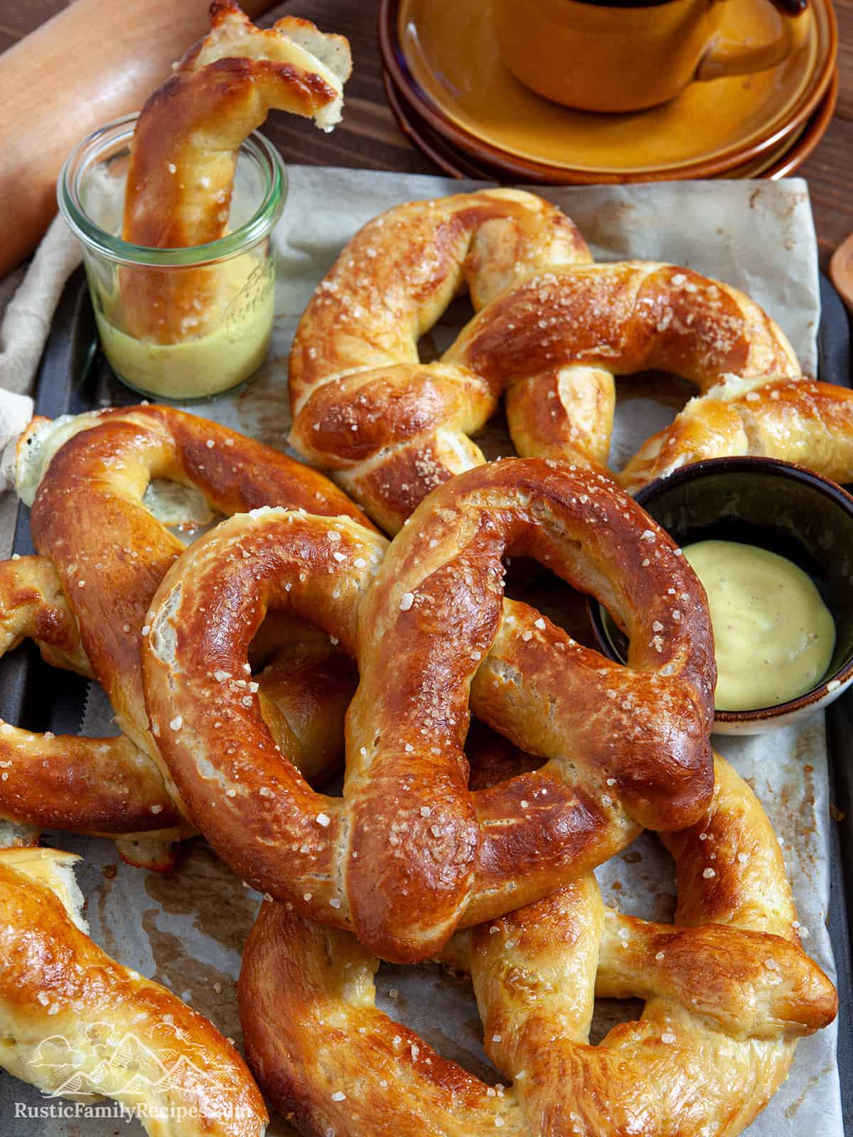 A baking sheet with a pile of jumbo pretzels