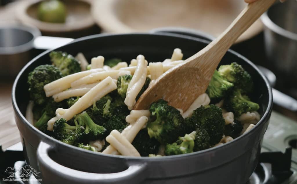 Adding cooked broccoli to pasta