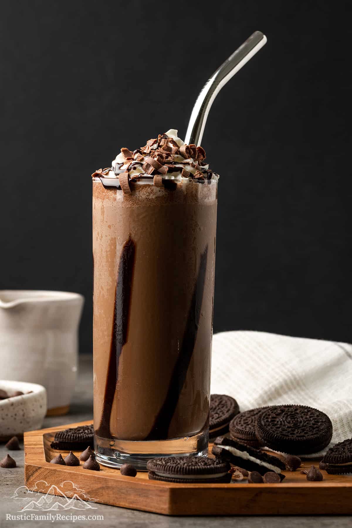 Mocha Cookie Crumble Frappuccino in a tall glass next to Oreo cookies
