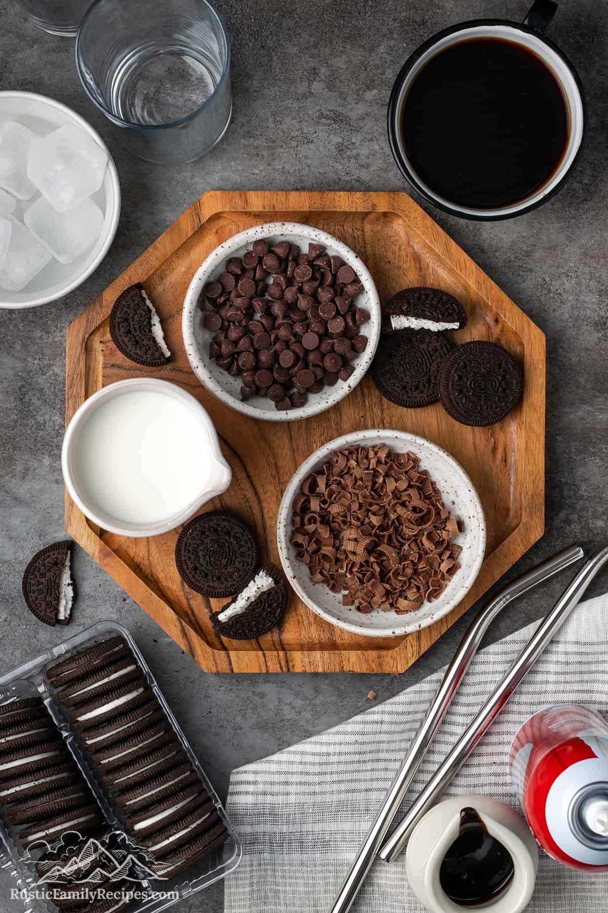 Chocolate chips, Oreo cookies, milk and other frappucino ingredients on a wood board