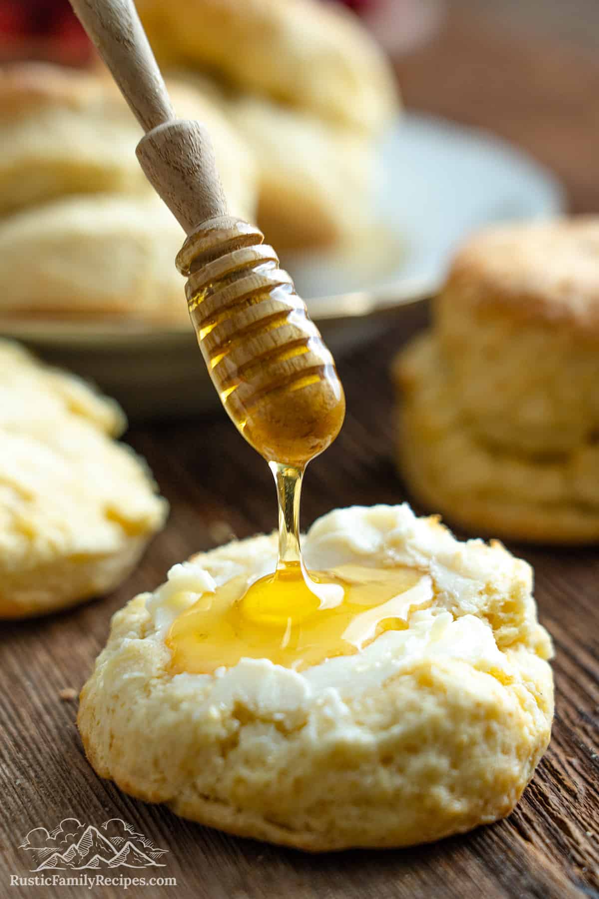 Drizzling honey on a buttermilk biscuit sliced in half