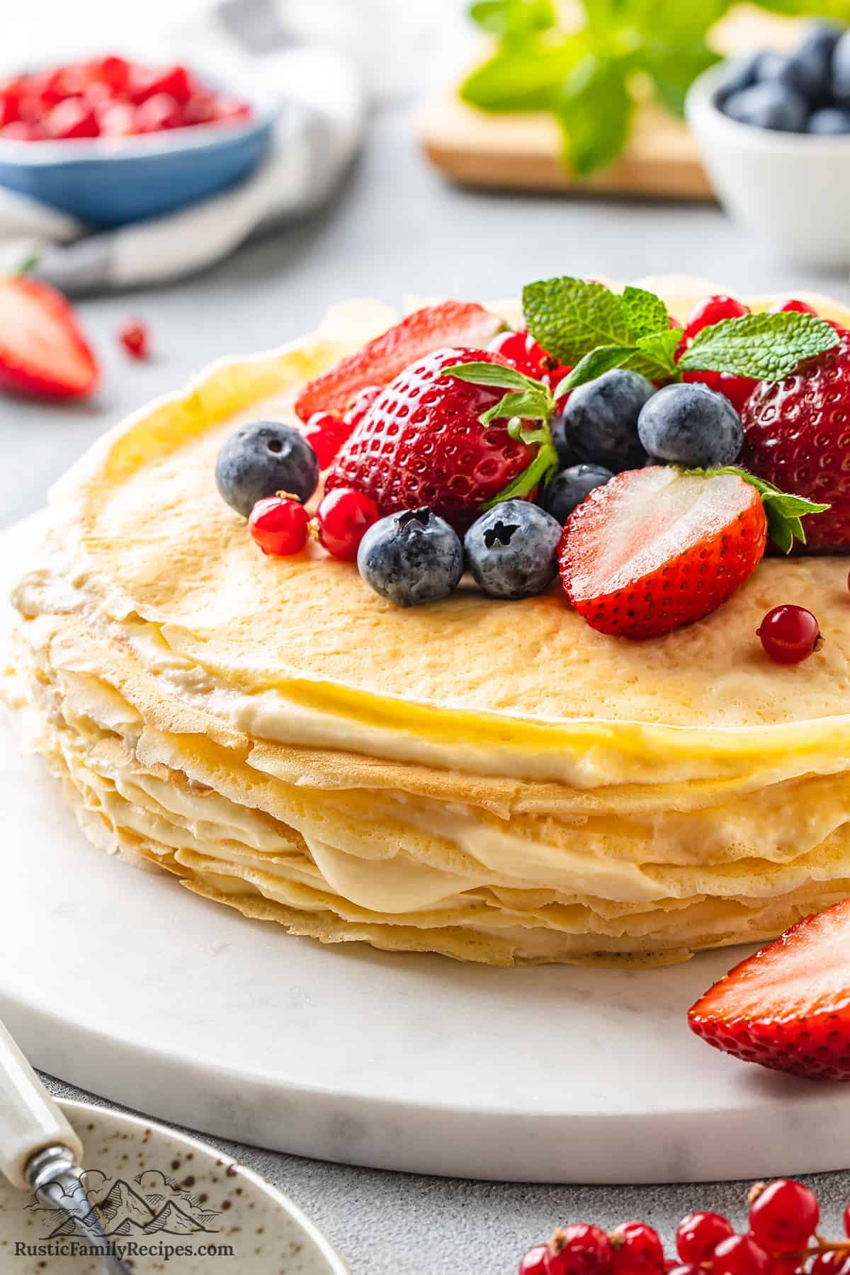 Side view of a Crepe Cake topped with fresh berries