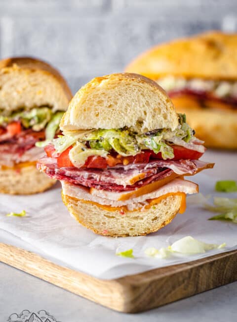 A slice of a grinder sandwich on a cutting board with other slices