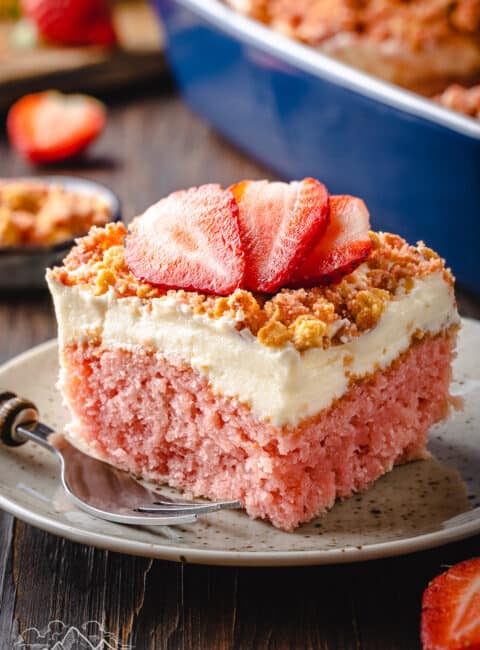 A slice of strawberry crunch cake on a rustic plate