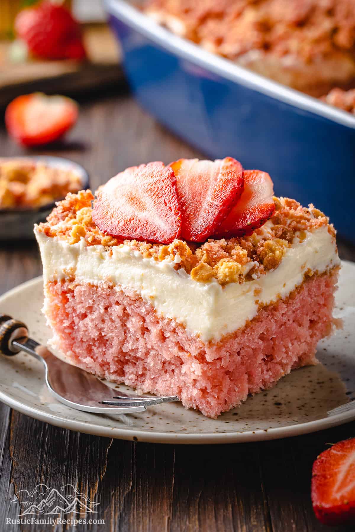A slice of strawberry crunch cake on a rustic plate