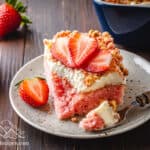 Slice of a Strawberry Crunch Cake with a bite taken out.