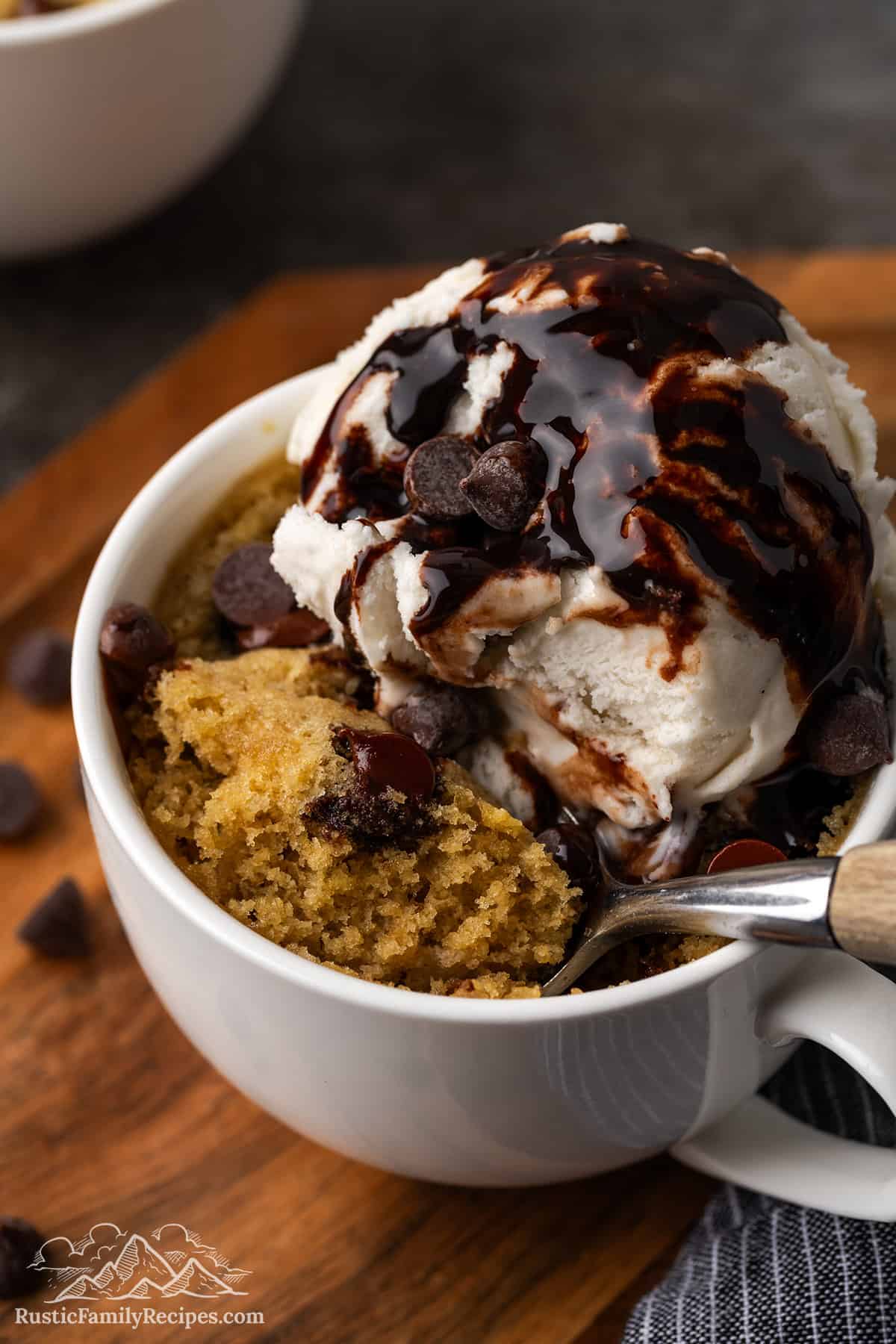 Chocolate chip cookie in a mug with ice cream and chocolate syrup