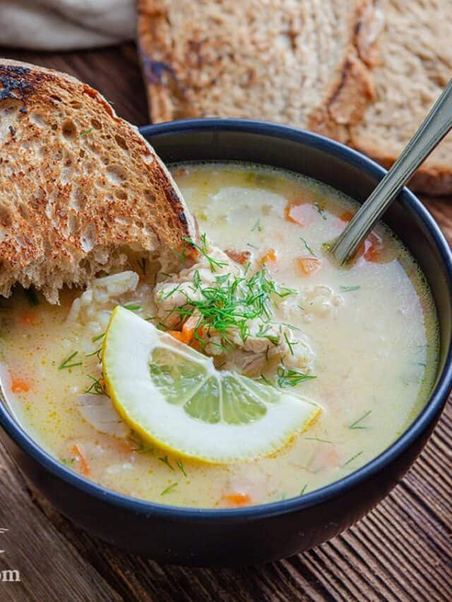 A bowl of Avgolemono Soup with two slices of bread