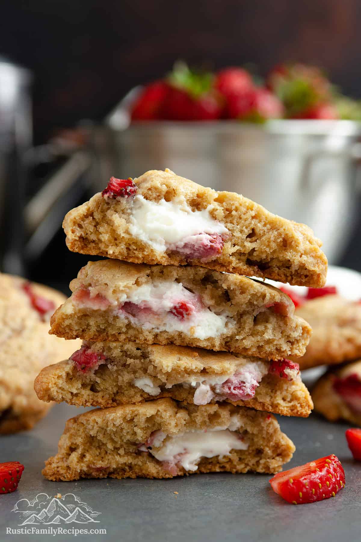 Stack of cookies broken in half, each one stuffed with cheesecake