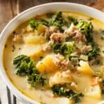 A white bowl filled with tuscan soup on a table