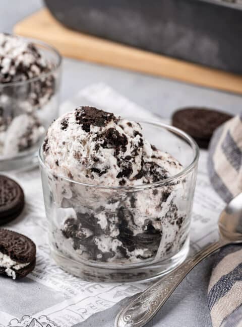 A scoop of Oreo ice cream in a glass cup