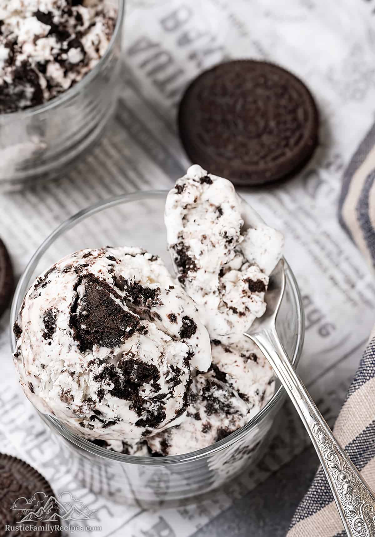 Oreo Ice Cream in a glass with a spoon taking a bite out