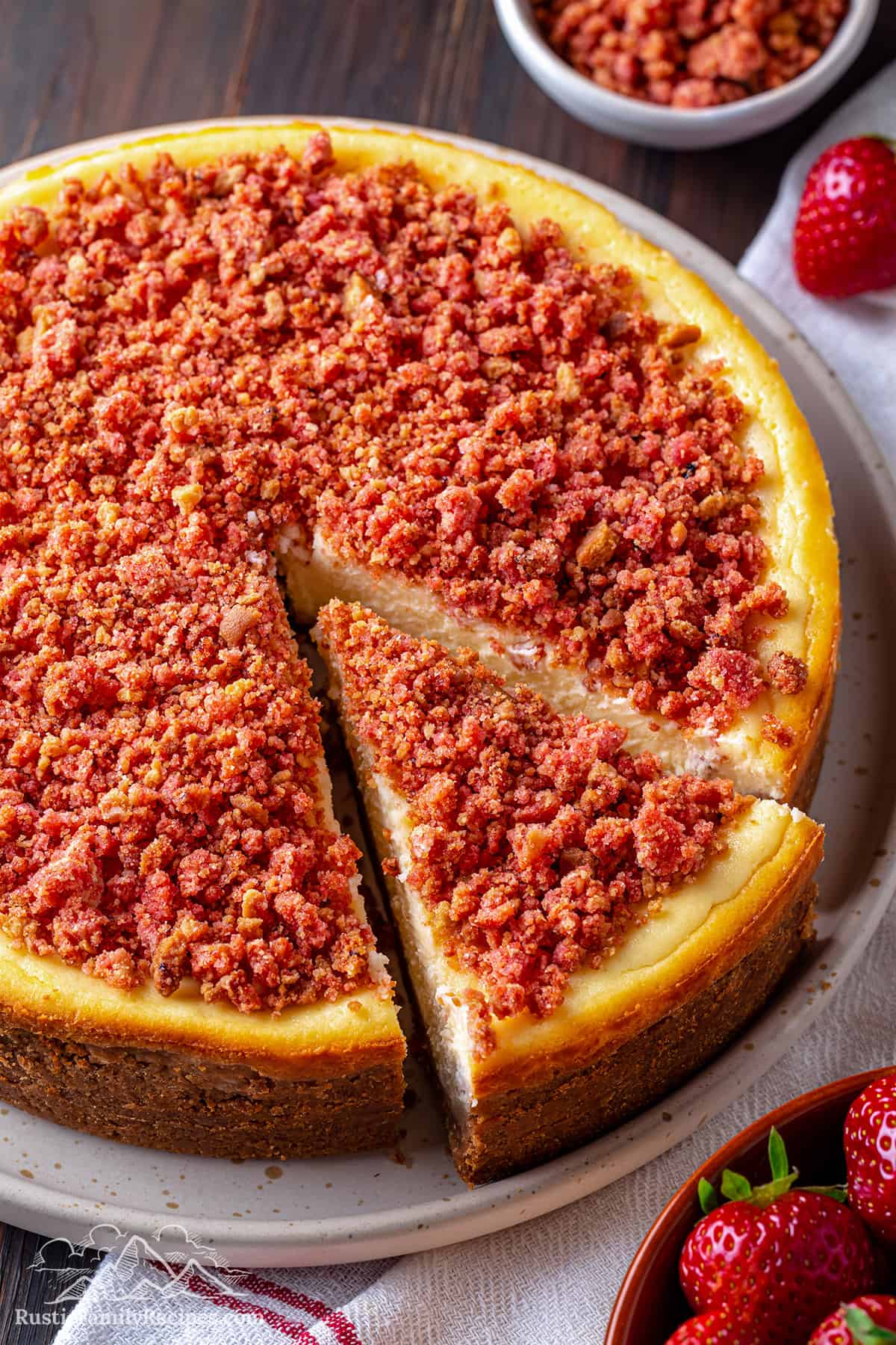 strawberry crunch cheesecake with a slice taken out