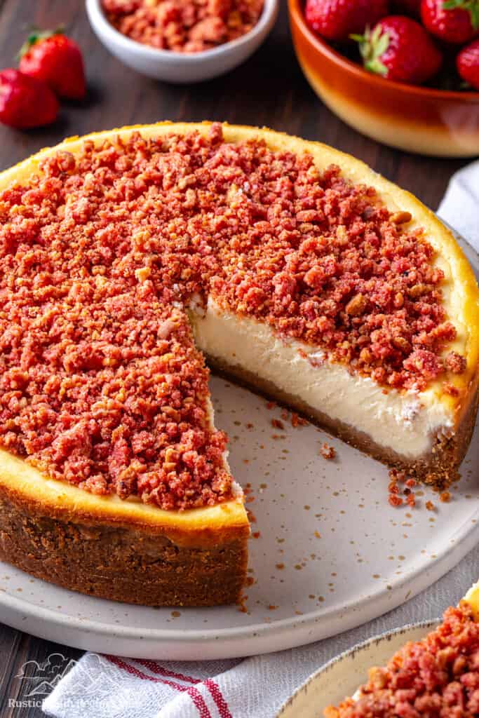 strawberry crunch cheesecake with a slice taken out