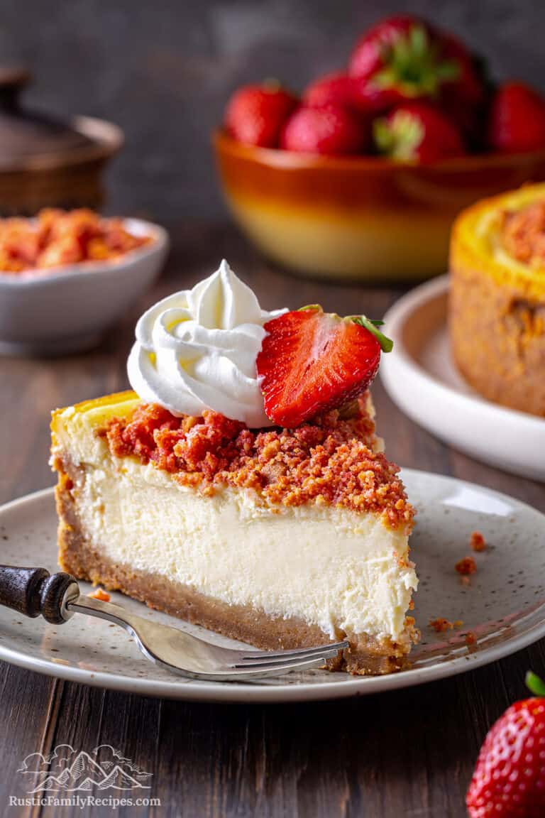 A slice of Strawberry Crunch Cheesecake on a plate
