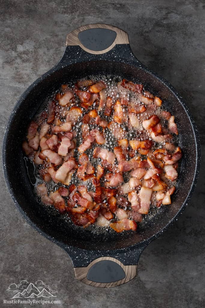 Cooked bacon bits in a deep pan