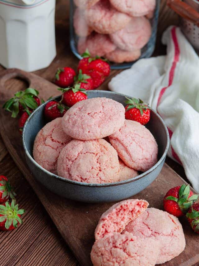Strawberry cookies in a bowl and on a cutting board