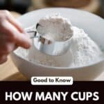 Hand scooping flour with a cup measure