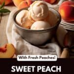 A metal bowl filled with peach ice cream, with peaches in the background