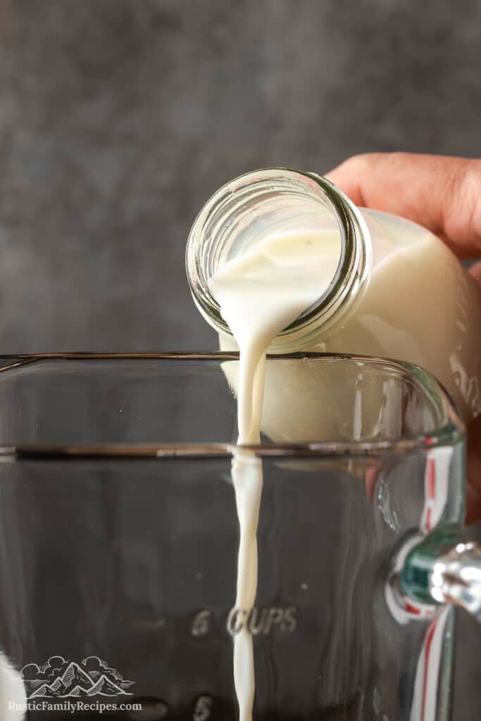 Pouring milk into a blender