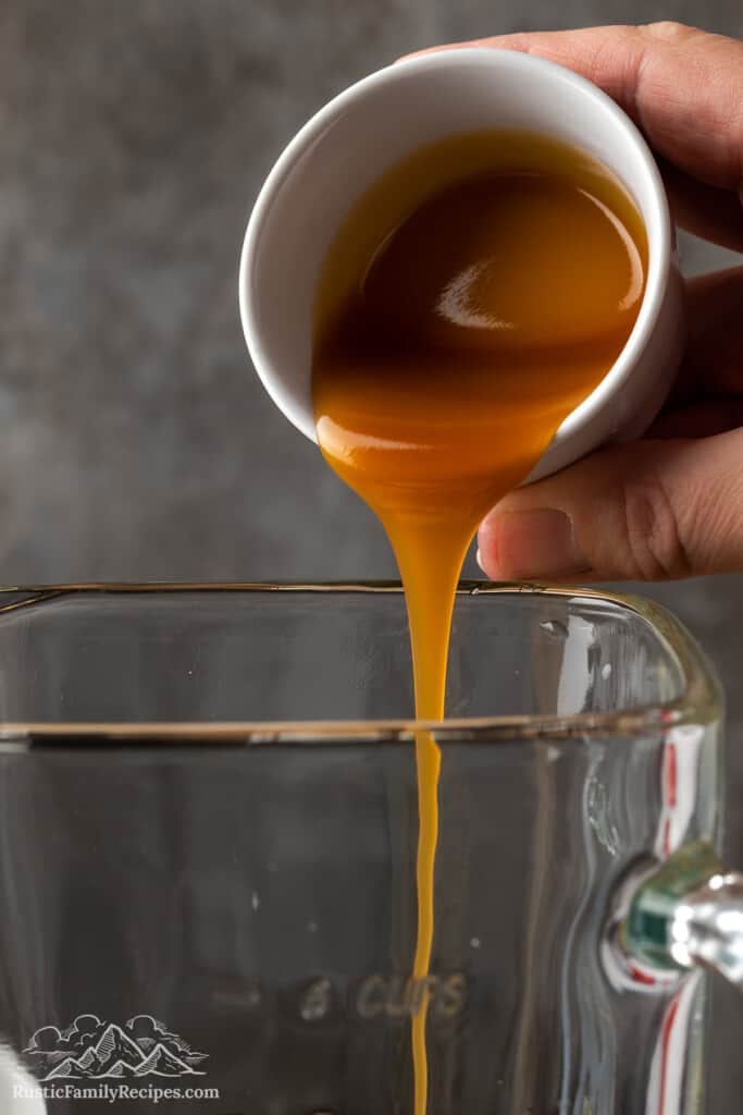 This Caramel Ribbon Crunch Frappuccino recipe comes together in minutes! An easy blended coffee drink with whipped cream & crushed caramel. Pouring caramel