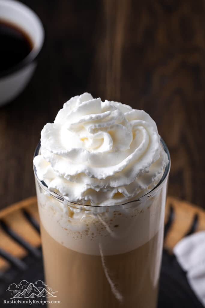 Adding whipped cream to a frappucino