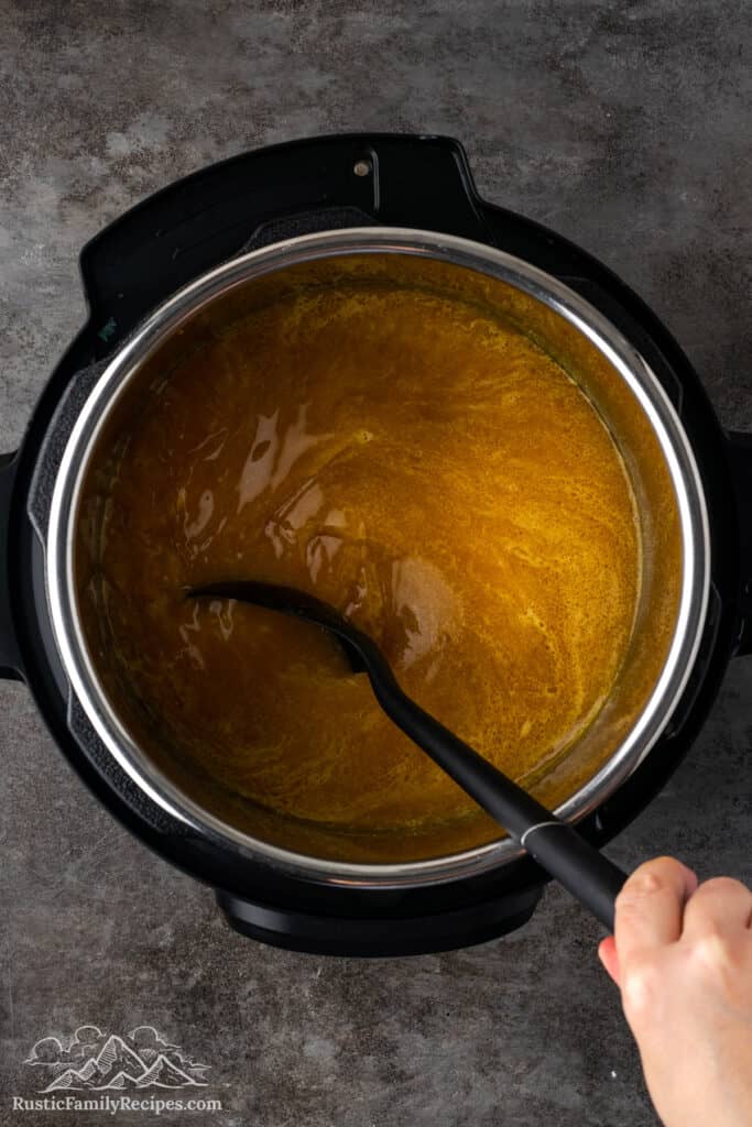 Stirring broth and spices in an Instant Pot