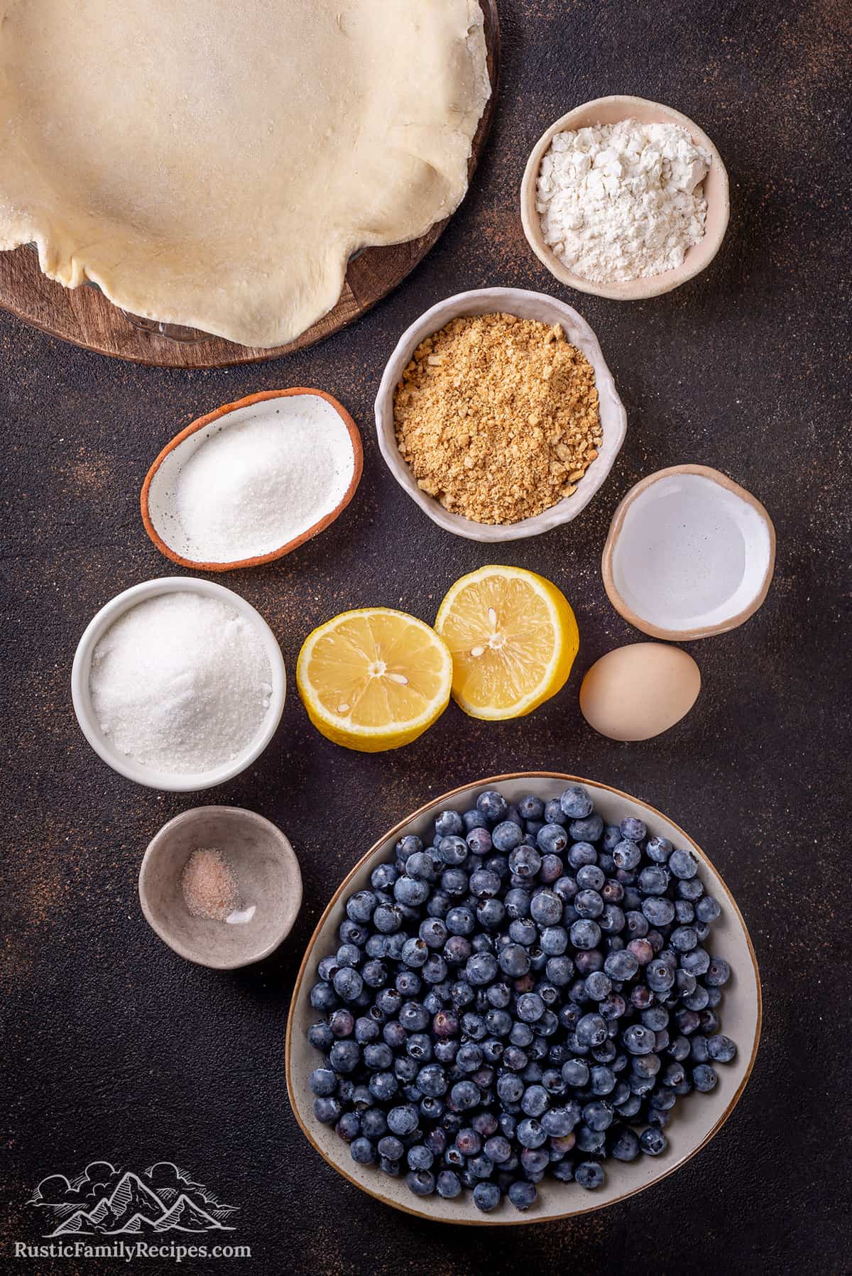 Ingredients for blueberry pie on a wood table
