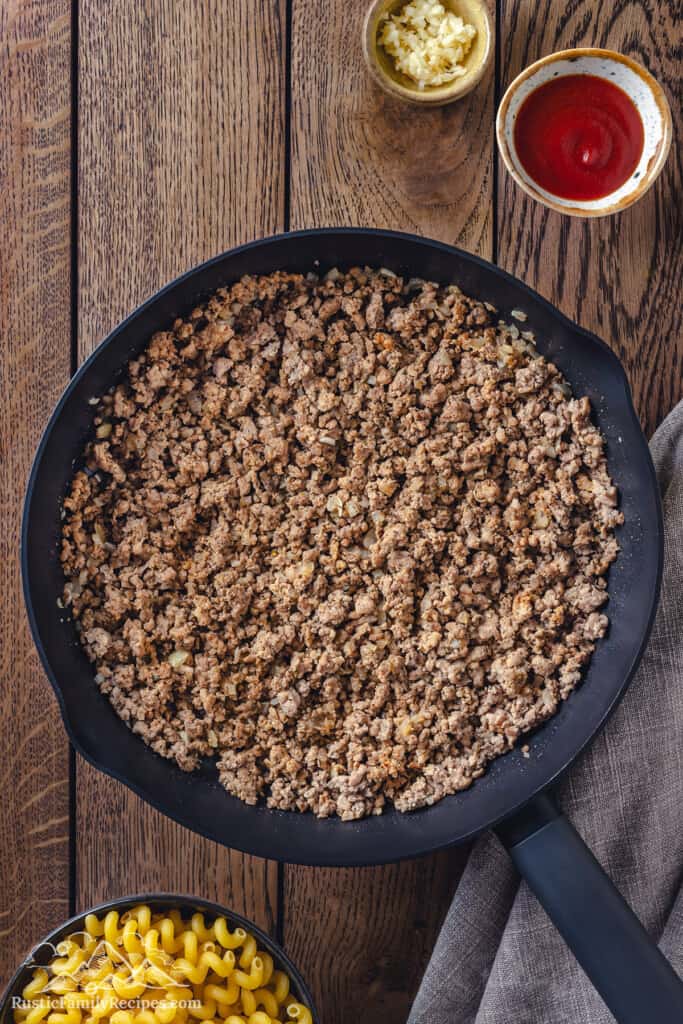 Browned ground beef in a cast iron skillet.