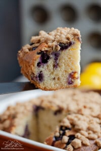 Spatula lifting a slice of lemon blueberry cake