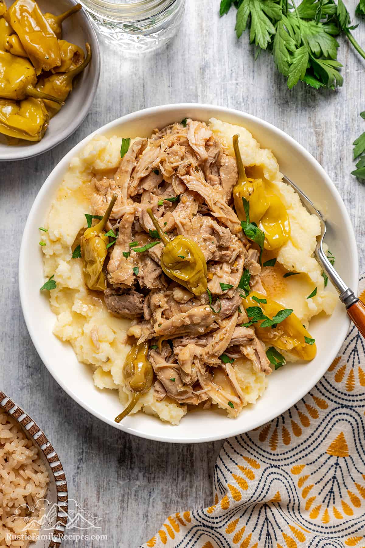Slow cooker Mississippi Chicken is easy and delicious. Simply load everyday ingredients into the slow cooker and set. A bowl of Mississippi Chicken served over mashed potatoes.